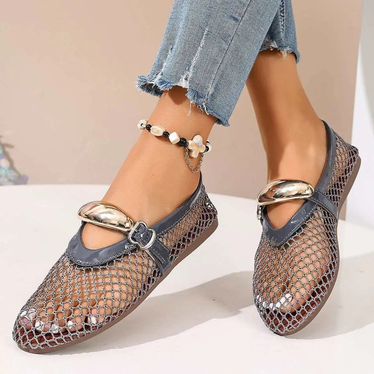 Women's Solarae elegant grey mesh flat sandals with a decorative polished buckle strap and patent trim, styled with distressed jeans and a beaded anklet.
