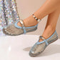 A pair of Solarae Sky Blue mesh flat sandals with patent faux leather trim and decorative gold buckle straps, shown on a model's feet with an anklet against a sparkling sequined backdrop.