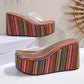 Bohemian stripe platform wedge slide sandals with a clear PVC upper strap, showcasing vibrant multi-colored vertical stripes on the substantial wedge.