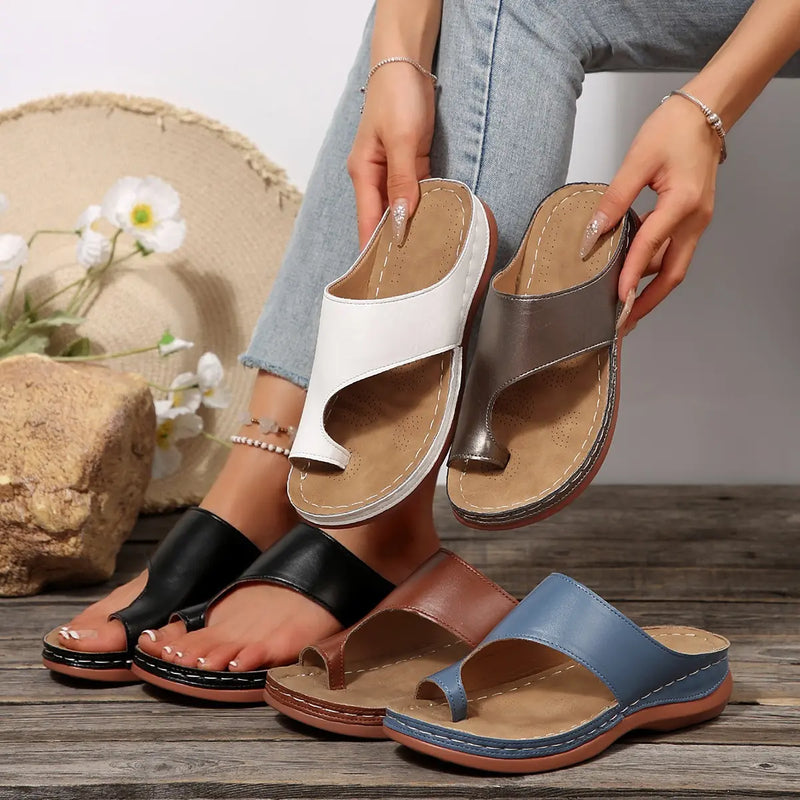 Collection of Svetik women's casual flat PU leather toe-post slides in multiple colors, including white, metallic grey, black, brown, and blue, shown in a lifestyle setting with a model wearing a pair.