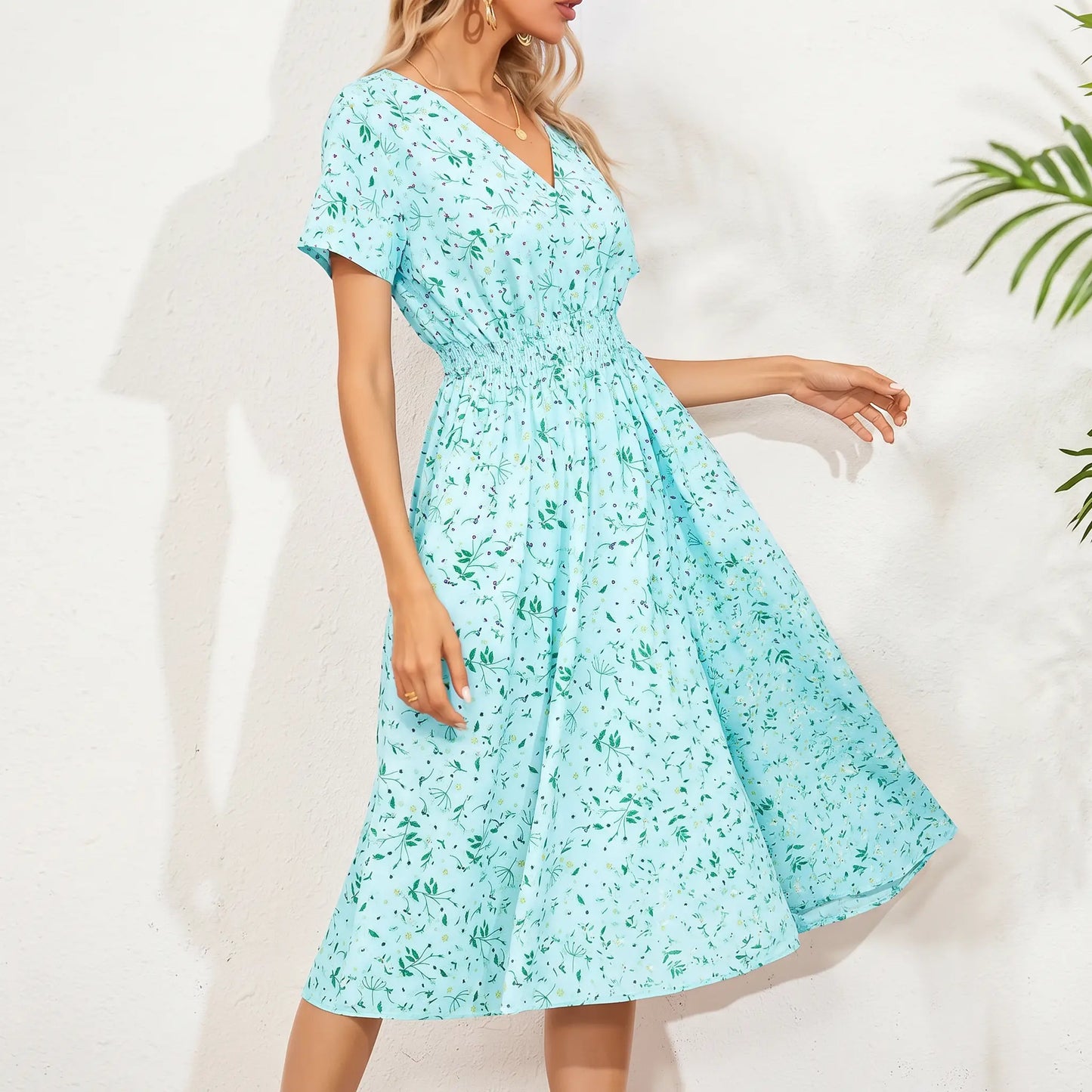 A women's light blue ditsy floral print midi dress with a V-neck, smocked waistband, and short flutter sleeves, shown on a model with a white textured background and shadow play.