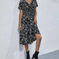 Talore women's V-neck midi dress in a dark floral print with short flutter sleeves, cinched waist, and A-line skirt, shown on a model.