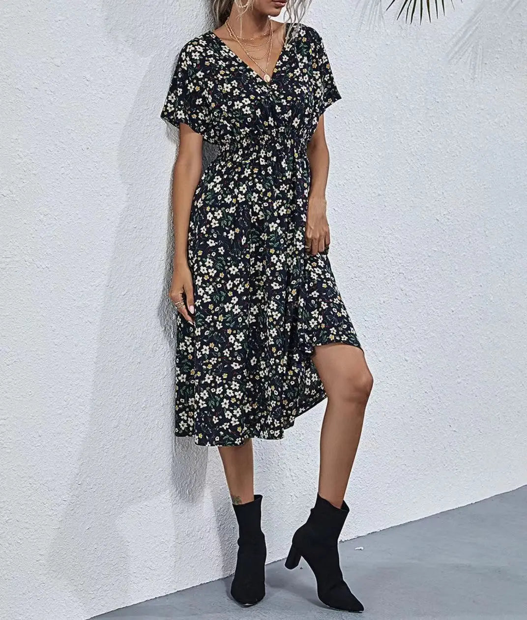 Talore women's V-neck midi dress in a dark floral print with short flutter sleeves, cinched waist, and A-line skirt, shown on a model.