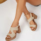 Women's tan suede-finish platform block heel sandals worn by a model, featuring an open toe, V-cut forefoot strap, and hook-and-loop ankle strap.