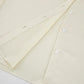 Close-up of the cream crinkle-pleated shirt from the Tarkem two-piece set, highlighting the vertical texture and clear tonal button placket.
