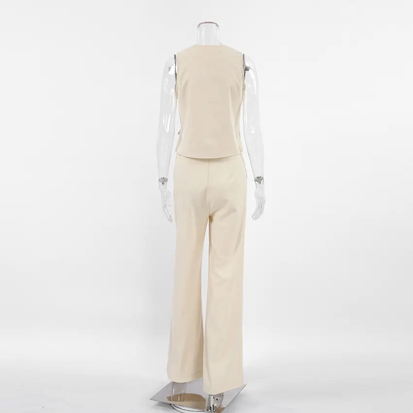 Back view of a women's two-piece set in soft beige linen blend, featuring a sleeveless vest and wide-leg trousers. The set is displayed on a mannequin against a white studio background.