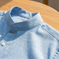 Close-up of a light blue Vandore mandarin collar linen shirt showing the detailed linen-weave texture and stand-up collar design.