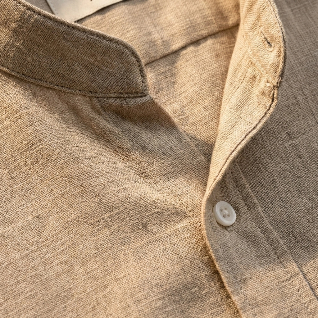 Close-up of a lime green mandarin collar linen shirt showing the textured fabric weave and white button detail.