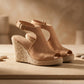 Vekri women's tan suede-like espadrille wedge sandals with peep-toe front and adjustable ankle strap, presented on a sandy surface with stones.