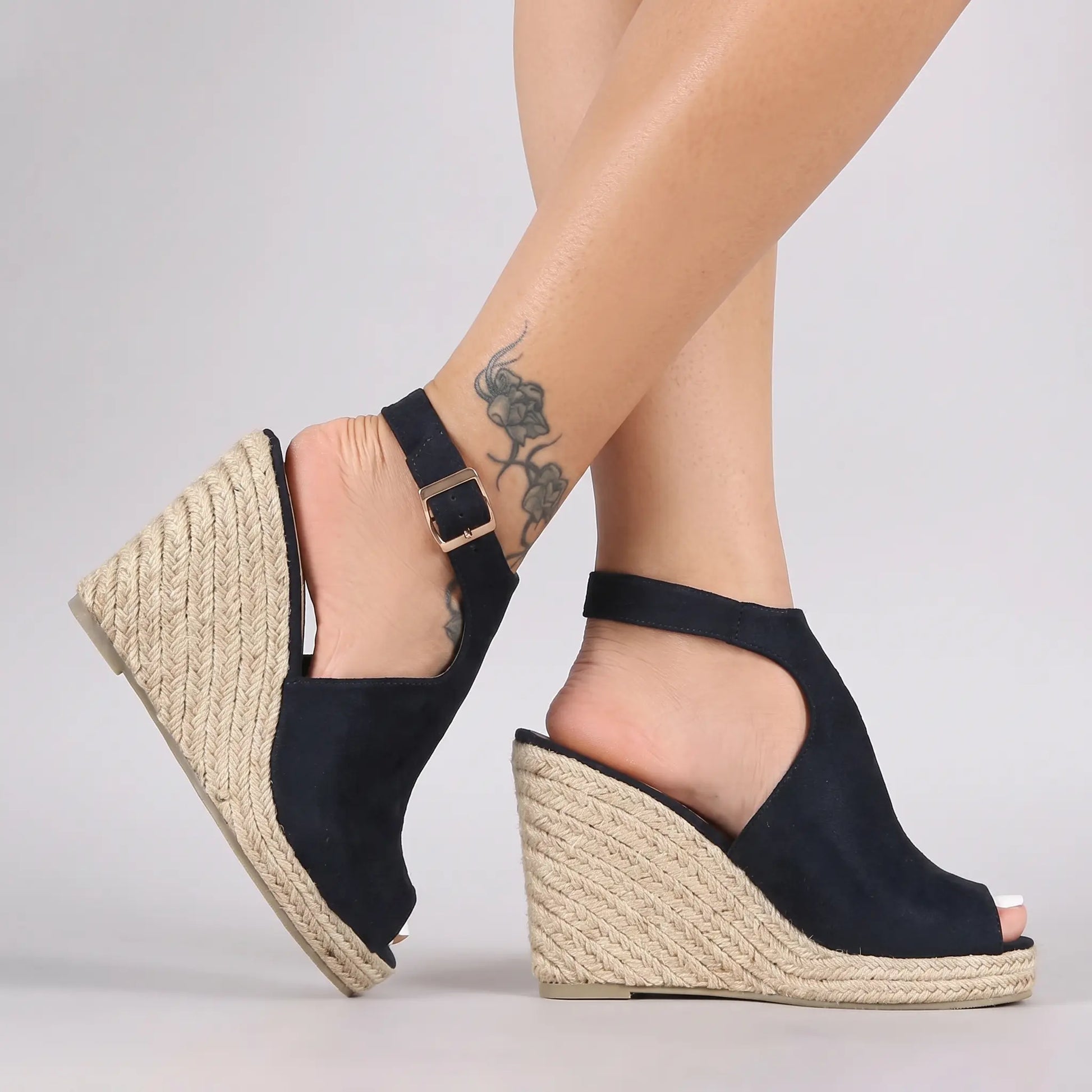 Vekri women's dark navy espadrille wedge sandals shown from the side view, featuring a peep-toe, ankle strap with gold buckle, and a natural jute woven wedge heel.