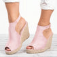 Vekri pink peep-toe espadrille wedge sandals with adjustable ankle strap and cut-out detailing, shown on feet with white jeans.