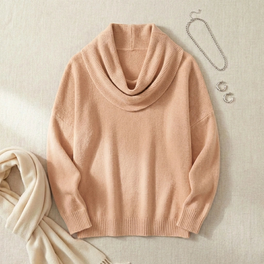 Vellura soft cowl neck knit sweater in apricot beige, styled flat lay showing the elegant draped neckline and ribbed cuffs.