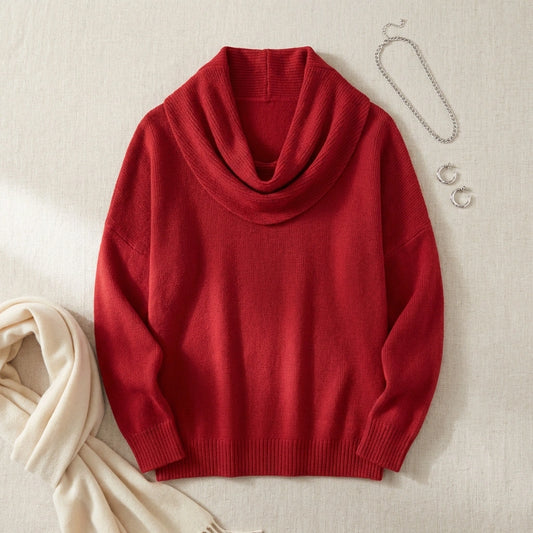 Vellura soft cowl neck sweater in red knit, flat-lay view showing the draped neckline styled with silver jewelry and a cream scarf.