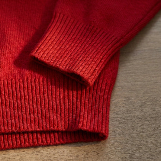 Vellura soft cowl neck sweater in red, close-up view showing the ribbed cuff detailing and premium knit texture.