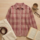 Vellura women's soft knit plaid shirt in dusty rose with a brushed texture, styled as a flat-lay with coffee, a book, and corduroy pants.