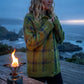 Vellura women's olive green soft knit plaid shirt with brushed texture, worn outdoors by the ocean at dusk.