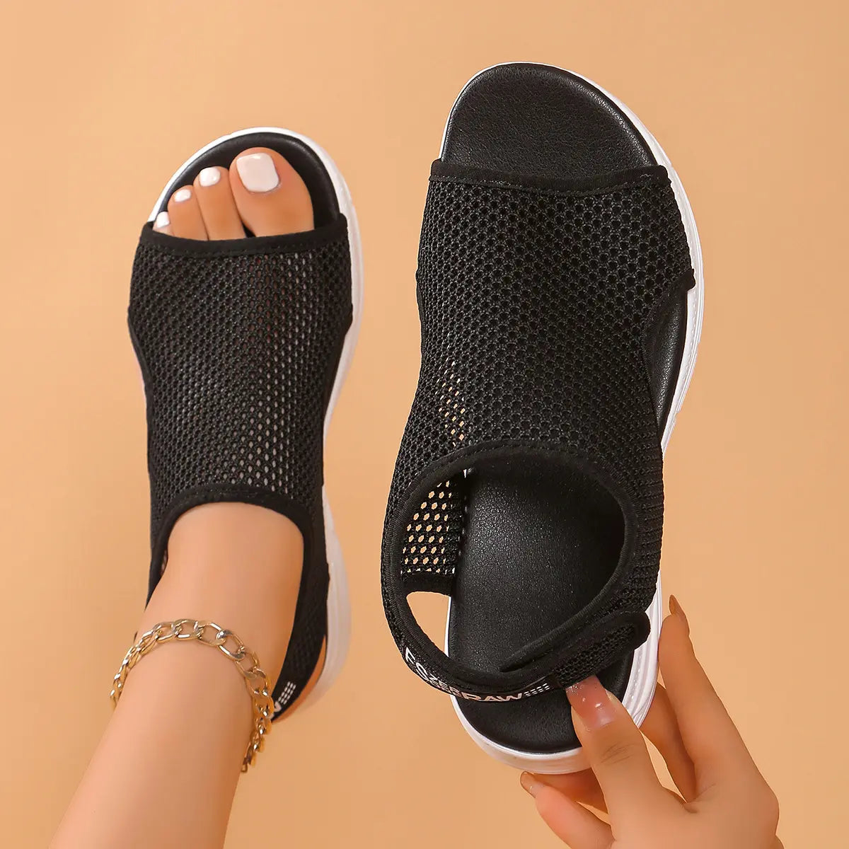 Black breathable mesh women's platform sandals with peep-toe and elastic heel strap, shown from a top-down angle on a studio background. Features a white layered sole and 'FSB' detail.