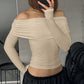 Vexlar elegant ruched off-shoulder top in warm beige, showing long sleeves and a form-fitting silhouette on a model.