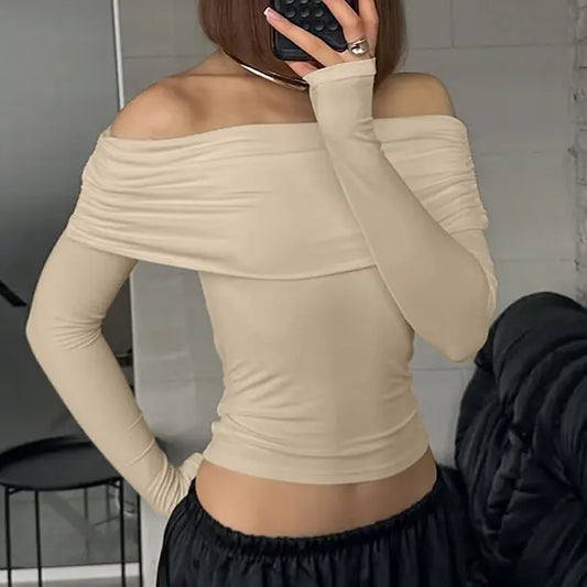 Vexlar elegant ruched off-shoulder top in warm beige, showing long sleeves and a form-fitting silhouette on a model.
