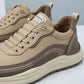 Vexor men's shock absorbing sneakers in khaki microfiber leather, three-quarter view showing the chunky EVA sole and side lettering details.