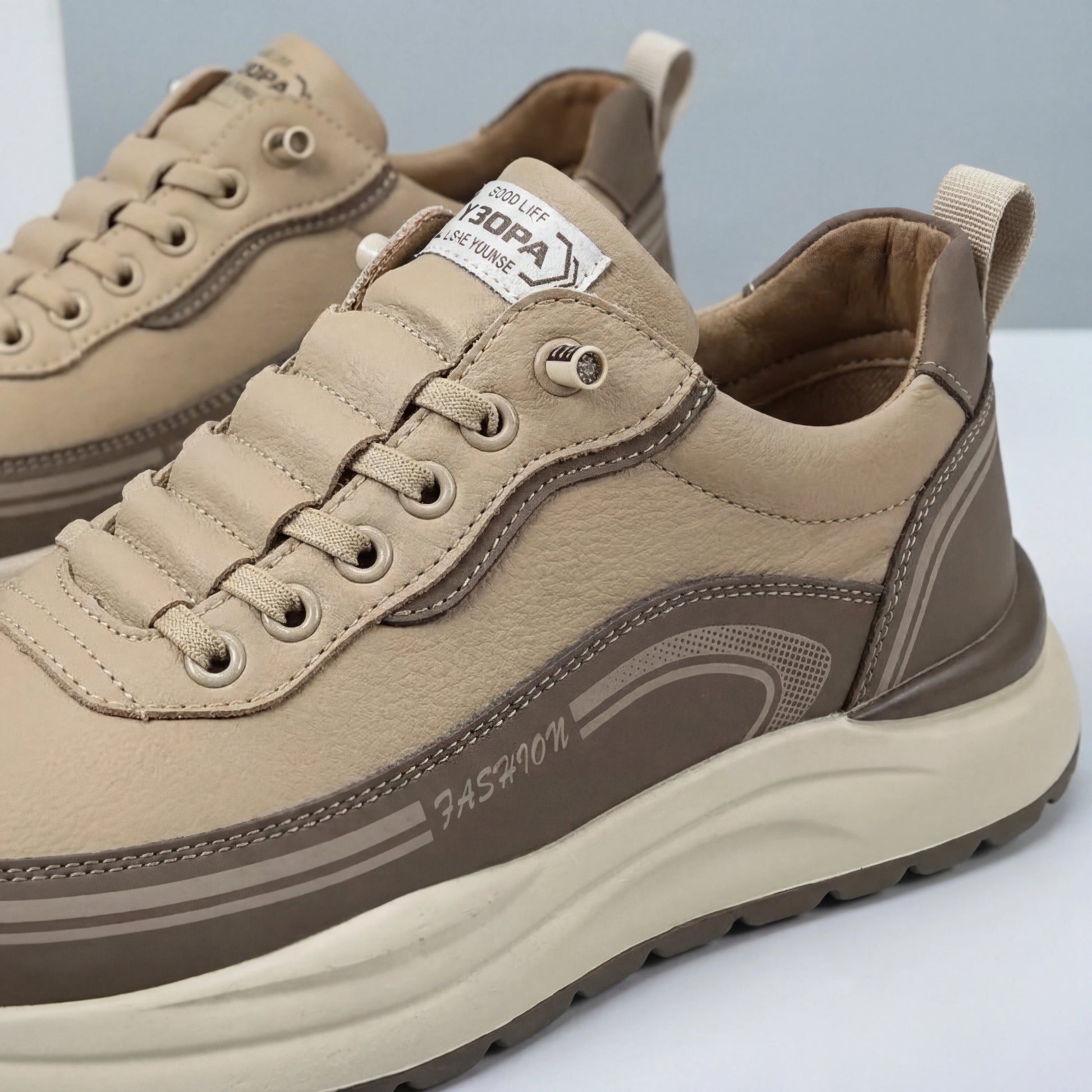 Vexor men's shock absorbing sneakers in khaki microfiber leather, three-quarter view showing the chunky EVA sole and side lettering details.