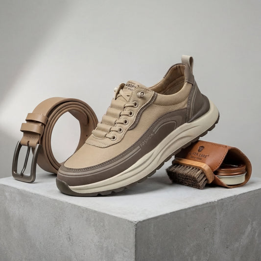 Vexor shock-absorbing urban sneakers in khaki microfiber leather, side view styled with a matching leather belt and shoe care kit on concrete.