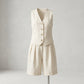 Creamy ecru linen-blend tailored vest and wide-leg pleated shorts set, front view on mannequin with mother-of-pearl buttons and cuffed hem.