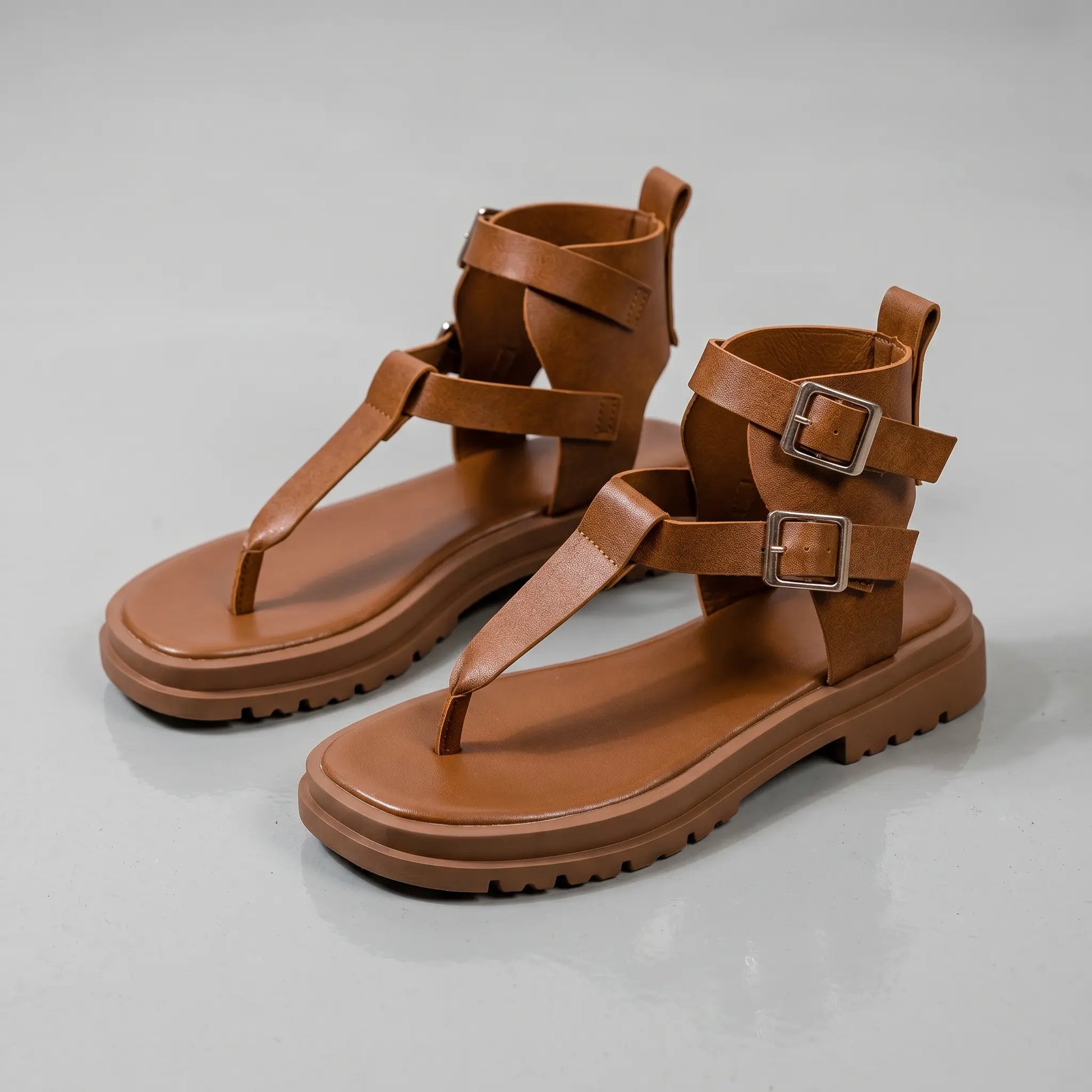 Vorlen women's rich chestnut faux leather gladiator sandals featuring a chunky platform sole, double brass-tone buckles on the ankle strap, and a thong post design. These open-toe sandals showcase a distinct heel cup with rear zipper.