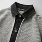 Close-up of Vornex hybrid cardigan in grey thermal knit and black denim, showing the structured collar and metal button detail.
