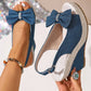 Vykos denim-look wedge sandals with a decorative bow embellished with crystals, featuring an espadrille-wrapped wedge heel and an adjustable slingback strap.