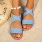 Vytka women's light blue textured Roman flat sandals with crossed elasticated slingback straps and a silver-tone metal ring embellishment, styled on a sandy beach with a straw mat.