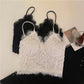 White and black Zyrin lace cropped camisoles laid flat, showcasing the delicate floral lace, eyelash trim V-neck, and slim spaghetti straps.