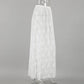 Side view of a floor-length white floral lace A-line maxi skirt, featuring a high waist, sheer fabric, and a natural lace hem.