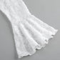 Close-up of a white lace blouse sleeve featuring a delicate floral pattern, voluminous bell shape, and sheer, flowing texture.