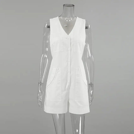 White sleeveless V-neck linen-blend romper with a button-down front, dual chest pockets, and decorative stitching on hip pockets, presented on a mannequin.