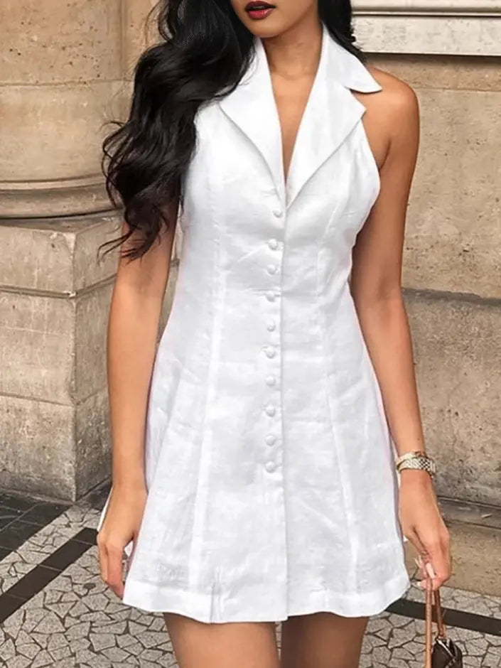 A white linen-blend halter neck A-line mini dress is modeled outdoors, featuring a wide collar, button-front detail, and a flared skirt.