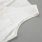 Close-up view of a white linen-blend romper, showcasing the sleeveless armhole, V-neckline detail, and a functional chest pocket with visible stitching.