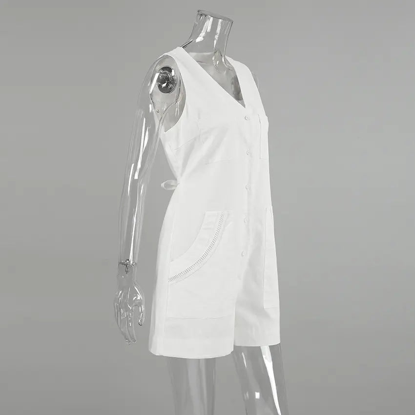 Side view of a white sleeveless linen-blend romper with a V-neck, button-down front, chest pockets, and decorative stitched hip pockets, displayed on a mannequin.