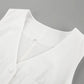 Close-up of a white linen-blend V-neck romper, showcasing the fabric texture, button detail, and chest pocket. The sleeveless design is visible.