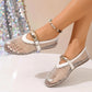 Women's luminous white mesh flat sandals with patent trim and decorative oval gold buckle strap, shown on a model's foot with an anklet.