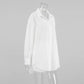 White textured cotton oversized shirt with a camp collar and button-down front, shown from a side view on a mannequin.