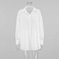 Front view of a white Xylos textured cotton oversized long-sleeved shirt with a camp collar and pearlescent button-down front.