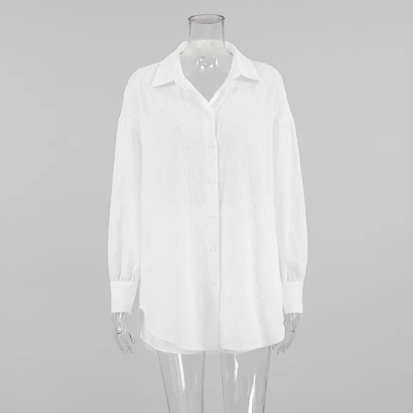 Front view of a white Xylos textured cotton oversized long-sleeved shirt with a camp collar and pearlescent button-down front.