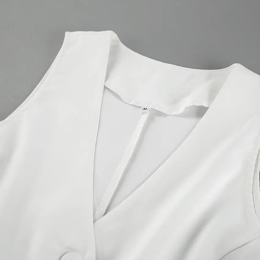 Close-up view of a pristine white sleeveless vest, showcasing the V-neckline, a visible size 'M' label, and fabric detail with a subtle sheen. High-quality garment construction is evident.