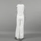 Back view of the white sleeveless V-neck vest and wide-leg trousers ensemble, showcasing the fluid drape and clean silhouette on a mannequin.