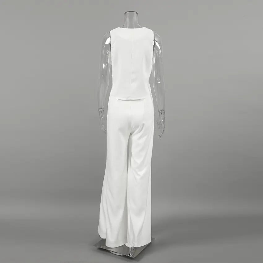 Back view of the white sleeveless V-neck vest and wide-leg trousers ensemble, showcasing the fluid drape and clean silhouette on a mannequin.