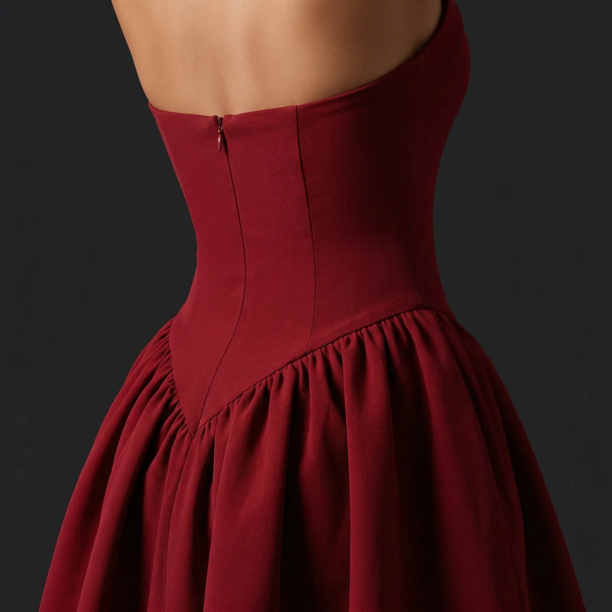 Close-up back view of a Wine Red Xalvek Romantic Basque Halter Dress, detailing the invisible zipper, structured basque waist, and voluminous gathered mini skirt.