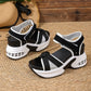 Women's black and grey woven textile platform sandals with a bow detail and hook-and-loop ankle straps, featuring a white stacked sole with a transparent air cushion heel unit.