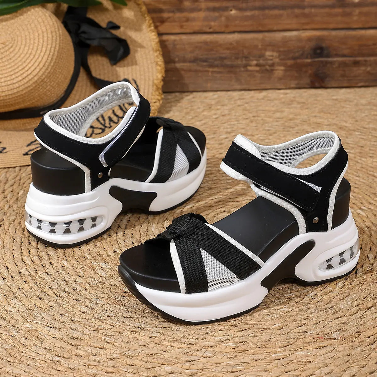 Women's black and grey woven textile platform sandals with a bow detail and hook-and-loop ankle straps, featuring a white stacked sole with a transparent air cushion heel unit.