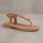 Bohemian flat thong sandal in Rich Earth Brown, featuring a woven patterned strap, floral beaded embellishment, and a distinctive stitched-effect sole.